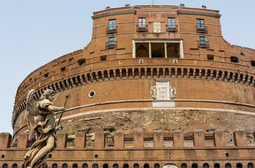 Low-angle view of Castel Sant Angelo in Rome, Italy under a clear blue sky