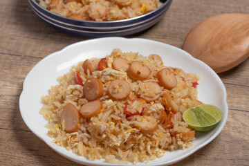 Sausage fried rice with egg and vegetables in white plate