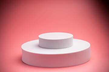 White product stand, mock up on a pink background texture background Ideal backdrop for product presentations, exhibitions and mockups.