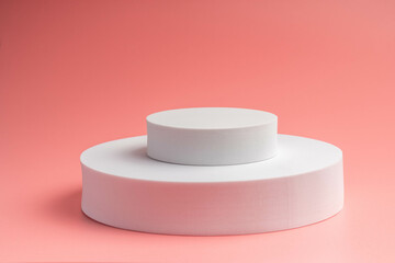 White product stand, mock up on a pink background texture background Ideal backdrop for product presentations, exhibitions and mockups.