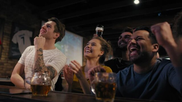 Group Of Friends Cheering To Soccer Match In The Pub. Shot With RED Helium Camera In 8K. 