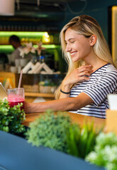 Portrait of happy woman smiling and using mobile phone. People technology social network concept