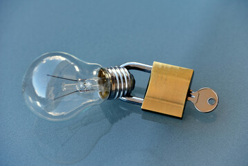 light bulb witth padlock on blue background