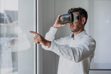 Businessman wearing virtual reality simulator in office