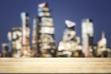 Empty tabletop made of wooden dies with blurry city view at dusk on background, template