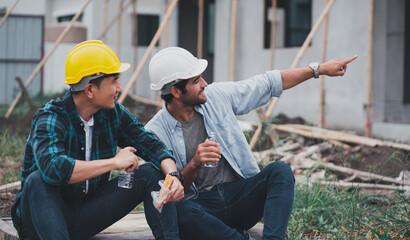 Engineering men are helping to plan the construction of the building.Engineer workers wear safety helmets.men at industrial work.