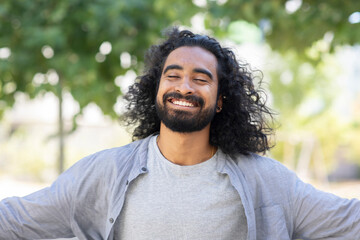 Happy bearded young man with long hair