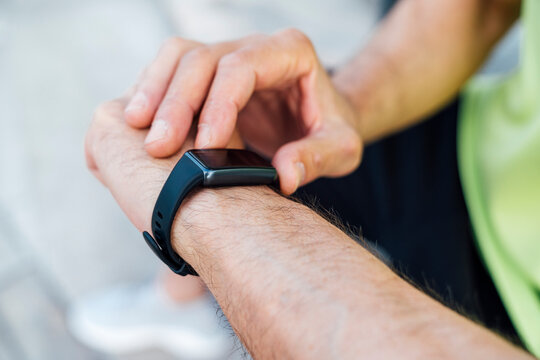 Mature man using fitness tracker - Powered by Adobe