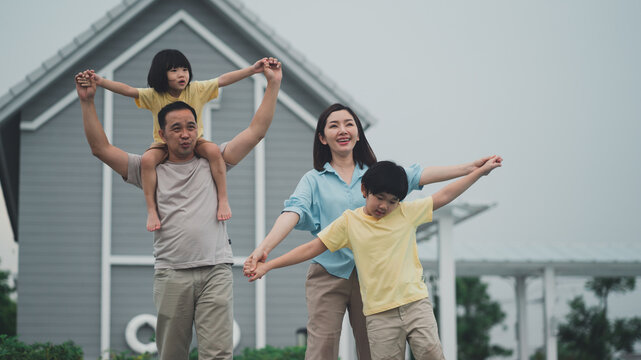 The family is happy because they can relax at a modern style holiday home.Husband and wife seem happy to be together with their children.The summer lifestyle is to take the family on vacation.