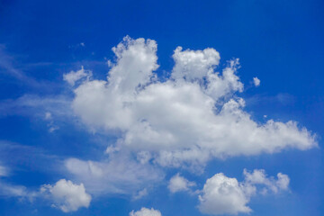 Naklejka na ściany i meble Puffy fluffy white clouds blue sky.