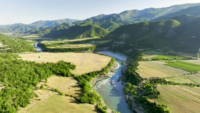 Rocky banks of Vjosa, river with turquise water flowing through mountains and green landscape, famous for rafting.  Albania.