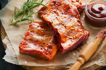 Pork ribs. Raw meat. Raw pork ribs in marinade with spices, rosemary, tomato sauce and garlic on...