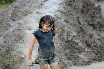 Naklejka premium Group of kids playing on muck in the raining day