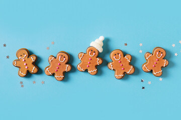 Row gingerbrads men on stick on blue background