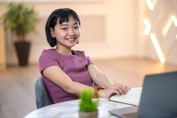 Short-haored girl looking involved while watching something online