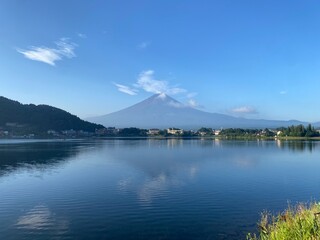 Beautiful thin clouds dances around the top of the Mt. Fuji, the summer view of the clear silhouette of Japanese world heritage, historic landmark, shore of Kawaguchiko Yamanashi, 2022/8/27