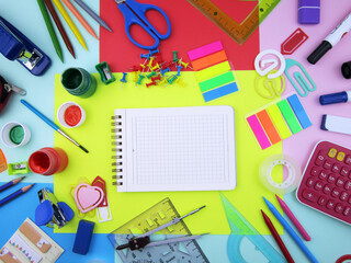     open notebook amid colorful school supplies                       