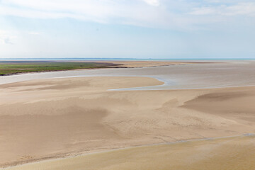 Beautiful view from the Mont Saint-Michel Abbey to the Atlantic Ocean at low tide. France