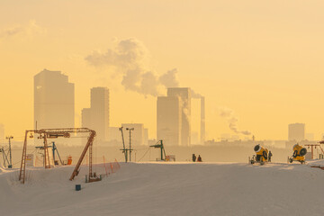 Ski resort with the foggy city in background at sunrise