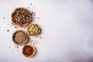 Different spices or seasonings in wooden bowls for tasty meals