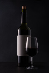 Bottle of wine with glass for tasting