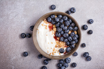 Fototapeta na wymiar Breakfast with yogurt, blueberries and granola