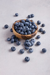 Fresh blueberry berries in wooden bowl