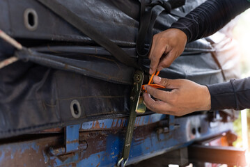 The trunk of the truck is covered with canvas and locked with plastic seal.
