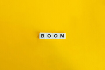 Boom Word on Block Letter Tiles on Yellow Background. Minimal Aesthetics. © photoopus