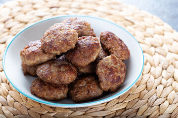 Minced meatball in bowl with eggs on the table. Homemade traditional Turkish meatballs.