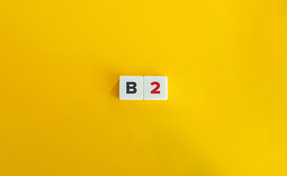 B2 Vitamin (Riboflavin). Block Letter Tiles on Yellow Background. Minimal Aesthetics.