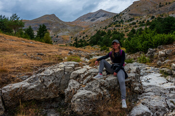 Naklejka na ściany i meble young woman relaxing in the mountains , adventure holidays lifestyle . France alps .