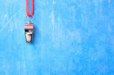 Whistle of soccer referee or trainer  on blue grungy background. Great soccer event this year,...