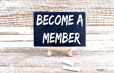 BECOME A MEMBER text on the Miniature chalkboard on wooden background