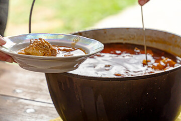 Cooking soup on the street in a cauldron