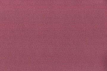 The texture of natural soft fabric is bright pink. Natural fabric background with a clear weave of threads.