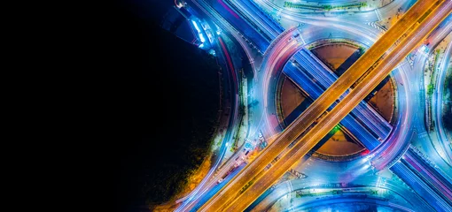 Foto op Canvas Expressway top view, Road traffic an important infrastructure,car traffic transportation above intersection road in city night, aerial view cityscape of advanced innovation, financial technology   © Hand Robot