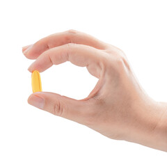 Palm with fingers holding one yellow capsule of Omega-3 fatty acid or fish oil food supplement...