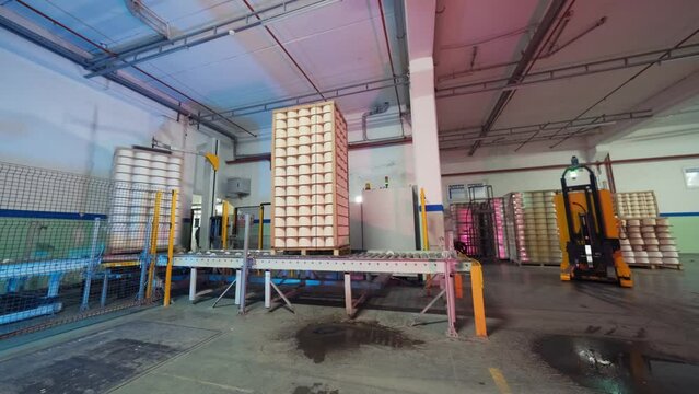 Yarn creel spools getting packed in an automatic machine in textile factory. 4K. modern factory.