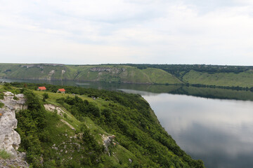 The high banks of a large river with calm smooth water. The rural landscape of Dniester river, Ukraine. Bakota Bay view.
