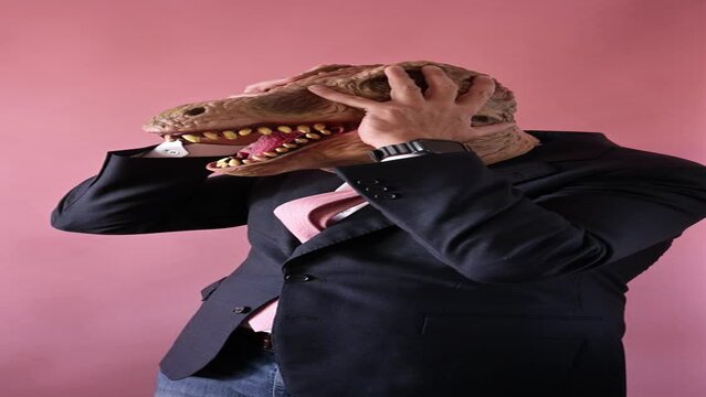 Man with the head of a lizard and bringing his hands to his head.