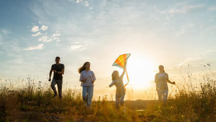 Fototapeta na wymiar Happy family at sunset