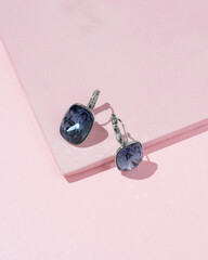 Silver earrings with round shaped sapphires, indigo crystals and diamonds isolated on white...