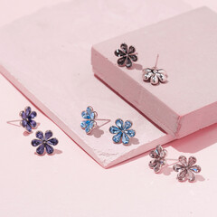 Stud earrings in the form of flowers of different colors with multi-colored crystals. Jewelry...