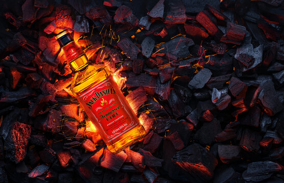 Ukraine, Kiev. November 12, 2020. Bottle of Jack Daniels Whiskey Tennessee Fire top view in burning coals.