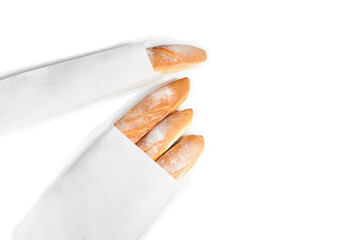 A French loaf in a white paper bag insulated on a white background. White bread in a craft bag. A paper bag full of bread.
