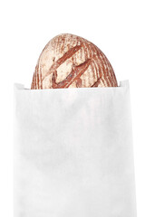 Black rye bread in a white paper bag. Bread half out of bag. Advertising for a bakery, space for a logo.
