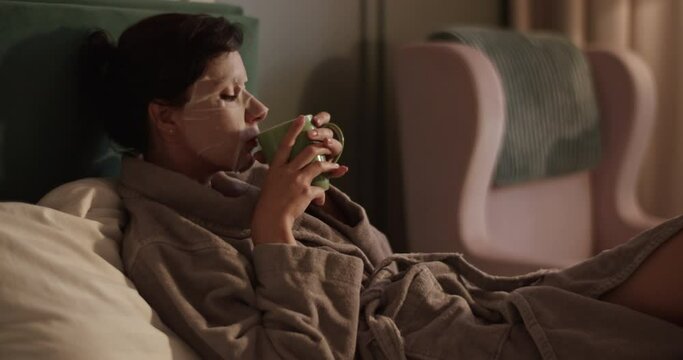 Woman drinking tea and watching TV