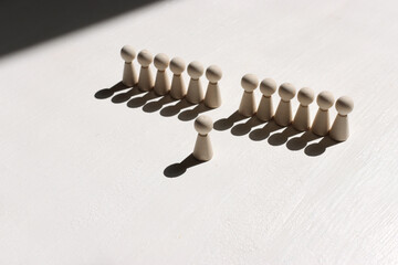 Concept image of wooden figures forming a wall. Leadership teamwork and strength metaphor