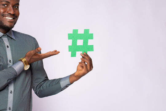 african businessman holding a hash tag symbol